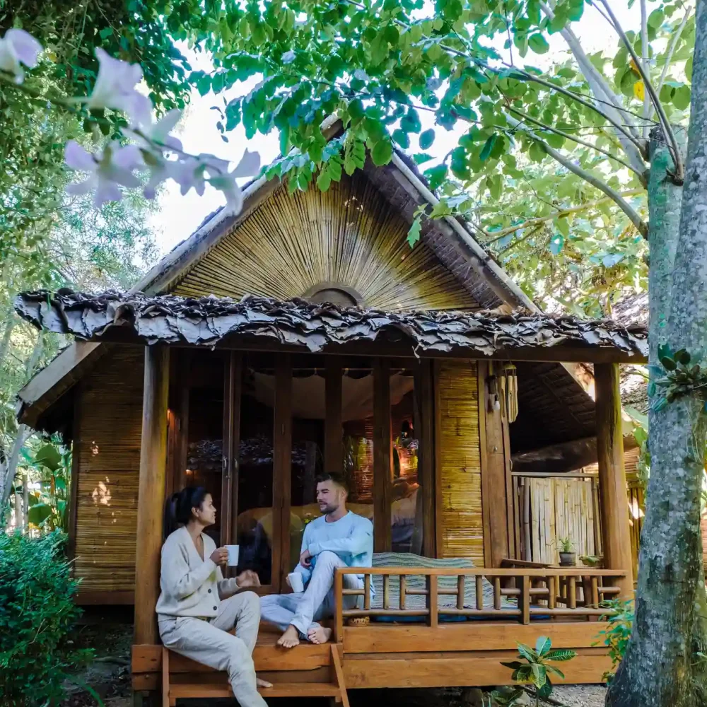 a-couple-of-men-and-women-at-a-bamboo-hut-homestay-2025-01-09-00-26-58-utc_result